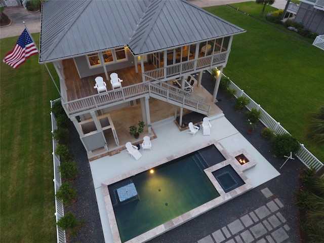 13830 Windlass Cir, Galveston, TX 77554 - back of house with a fire pit, a patio, stairs, and metal roof