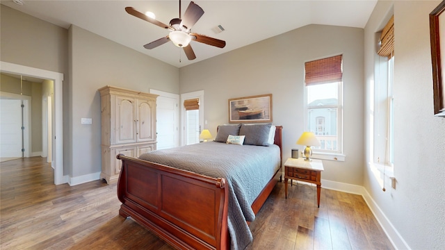 13830 Windlass Cir, Galveston, TX 77554 - bedroom with lofted ceiling, wood finished floors, baseboards, and ceiling fan