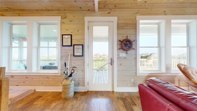 13830 Windlass Cir, Galveston, TX 77554 - doorway to outside featuring wooden walls, wood finished floors, and baseboards