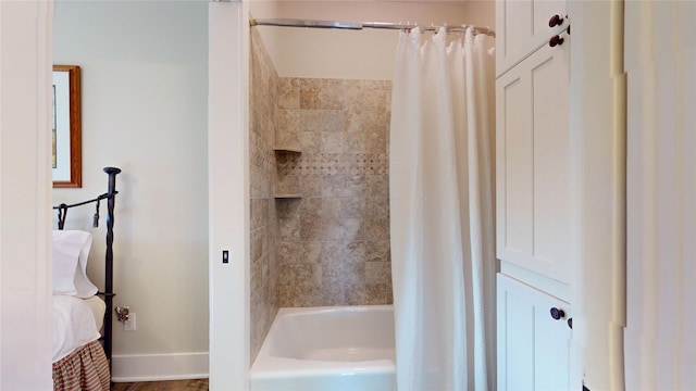 13830 Windlass Cir, Galveston, TX 77554 - bathroom featuring shower / bath combo with shower curtain and baseboards