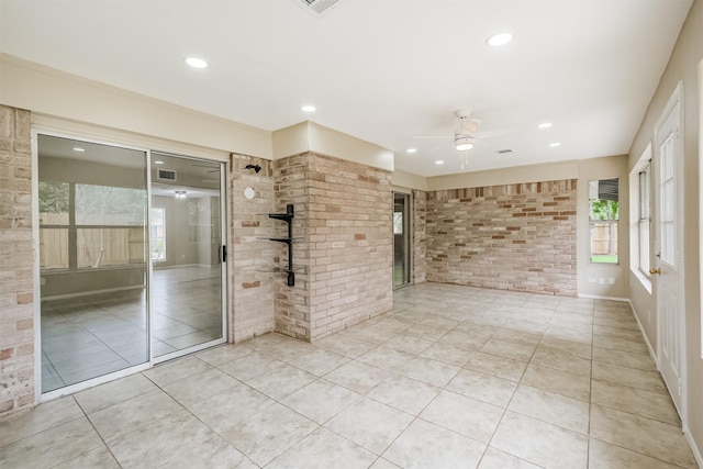 2738 Kettle Run, Sugar Land, TX 77479 - tiled empty room featuring ceiling fan, brick wall, and recessed lighting