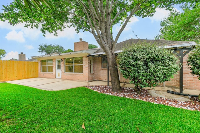 2738 Kettle Run, Sugar Land, TX 77479 - back of property featuring brick siding, a chimney, a patio, and a shingled roof