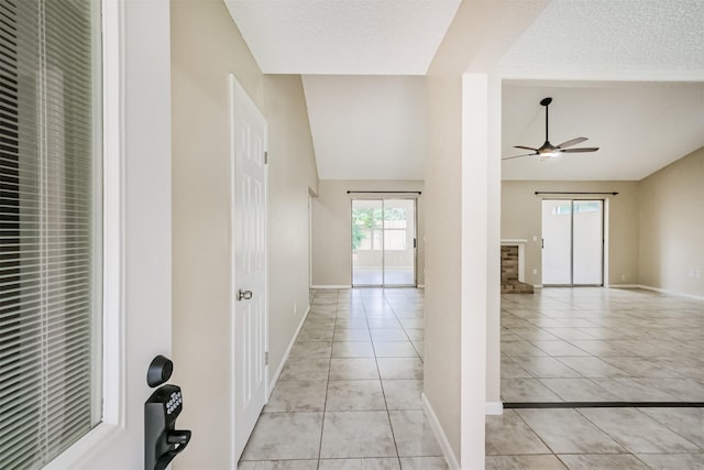 2738 Kettle Run, Sugar Land, TX 77479 - corridor with vaulted ceiling, light tile patterned floors, baseboards, a textured ceiling, and a heating unit