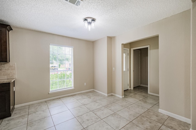 2738 Kettle Run, Sugar Land, TX 77479 - unfurnished living room with light tile patterned floors and a textured ceiling