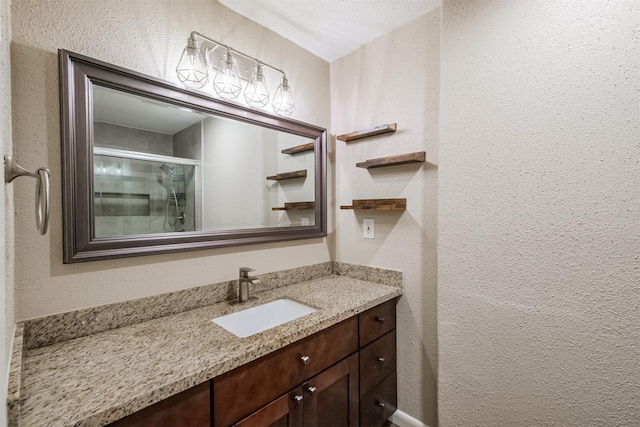 2738 Kettle Run, Sugar Land, TX 77479 - bathroom with a textured wall, vanity, and a stall shower