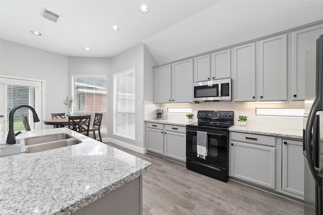 1706 Maddie Springs Ct, Spring, TX 77386 - kitchen with appliances with stainless steel finishes, a sink, gray cabinetry, light wood-style floors, and recessed lighting