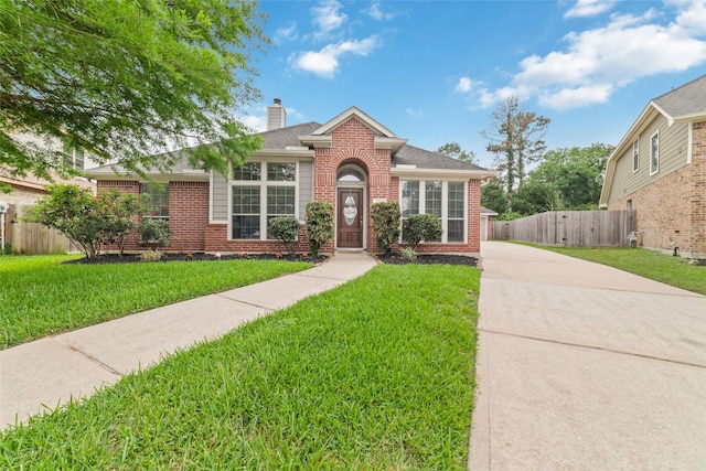 1706 Maddie Springs Ct, Spring, TX 77386 - view of front of property featuring brick siding, a chimney, concrete driveway, and a gate