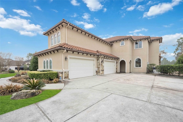 4510 Siandra Creek Ct, Spring, TX 77386 - mediterranean / spanish-style house with driveway, stucco siding, stone siding, a tile roof, and an attached garage