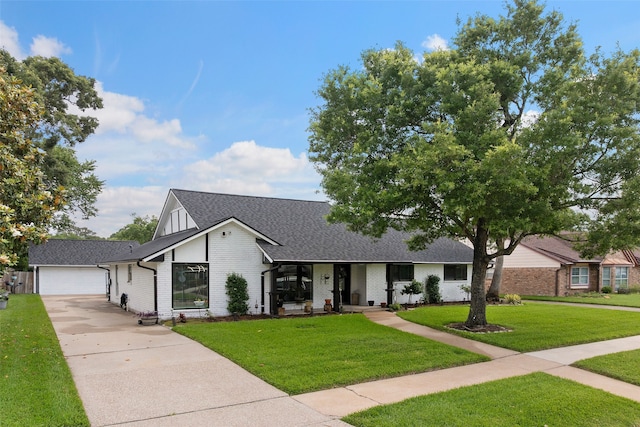 918 Hollow Tree St, La Porte, TX 77571 - view of front of property with driveway, brick siding, a front lawn, roof with shingles, and a garage