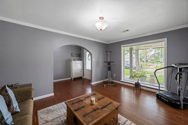 918 Hollow Tree St, La Porte, TX 77571 - workout area with arched walkways, crown molding, wood finished floors, baseboards, and a textured ceiling
