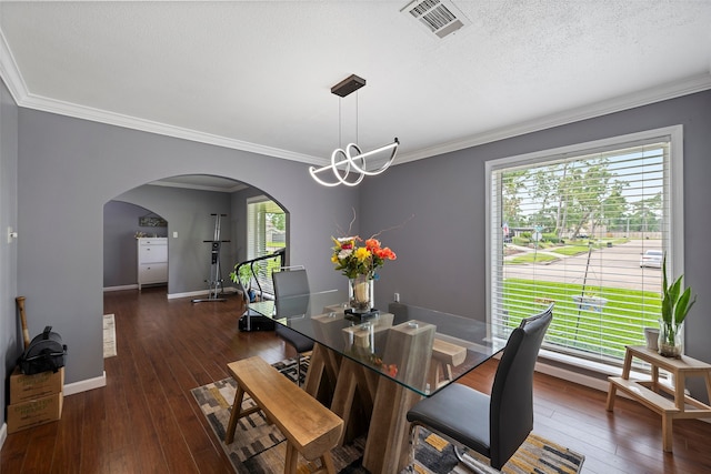 918 Hollow Tree St, La Porte, TX 77571 - dining area featuring arched walkways, dark wood-type flooring, crown molding, a chandelier, and baseboards