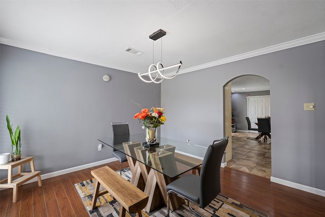 918 Hollow Tree St, La Porte, TX 77571 - dining room with arched walkways, crown molding, baseboards, and wood finished floors