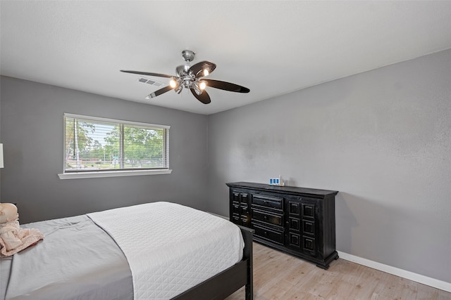 918 Hollow Tree St, La Porte, TX 77571 - bedroom with light wood-type flooring, baseboards, and a ceiling fan