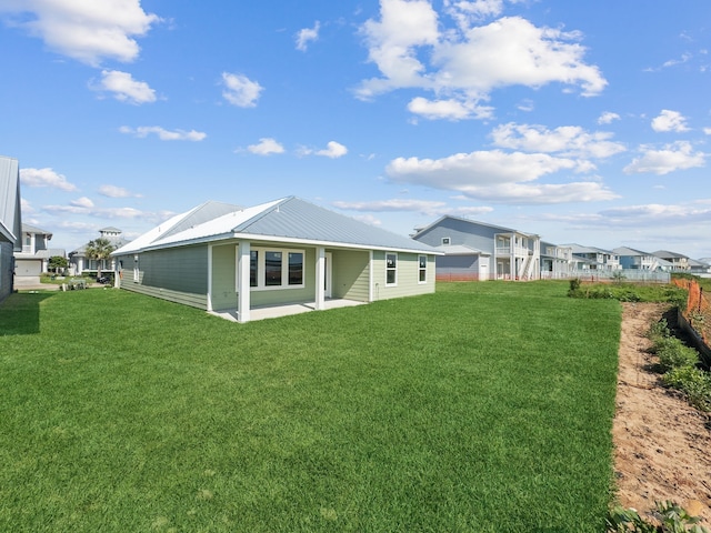 5218 Allen Cay, Texas City, TX 77590 - rear view of house with a patio area, a lawn, metal roof, and a residential view