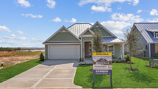 5218 Allen Cay, Texas City, TX 77590 - view of front of home featuring concrete driveway, a garage, a front lawn, metal roof, and a standing seam roof