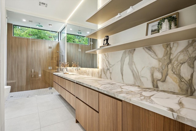 11206 Tyne Ct, Houston, TX 77024 - full bath featuring a marble finish shower, double vanity, tile patterned flooring, and tasteful backsplash