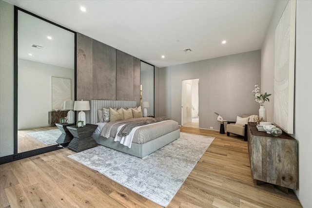 11206 Tyne Ct, Houston, TX 77024 - bedroom featuring light wood-type flooring, recessed lighting, and connected bathroom