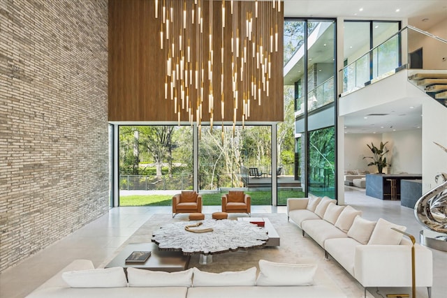 11206 Tyne Ct, Houston, TX 77024 - common area with a towering ceiling, a wall of windows, and brick wall