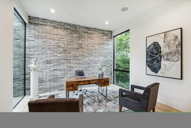 11206 Tyne Ct, Houston, TX 77024 - office area with light wood-type flooring, brick wall, and recessed lighting