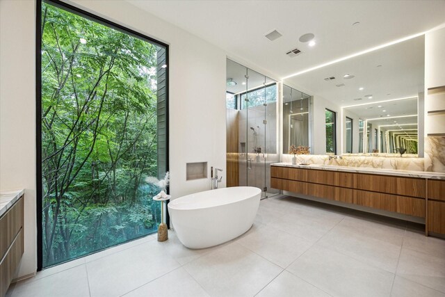 11206 Tyne Ct, Houston, TX 77024 - full bath featuring vanity, a stall shower, a freestanding tub, and tile patterned floors