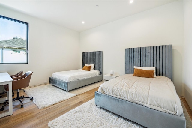 11206 Tyne Ct, Houston, TX 77024 - bedroom with wood finished floors, recessed lighting, and an office area