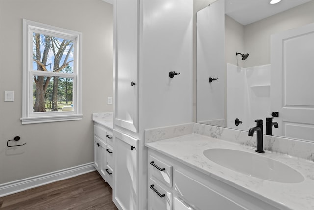 595 Fm 2968, Grapeland, TX 75844 - full bathroom featuring vanity, baseboards, wood finished floors, and a shower