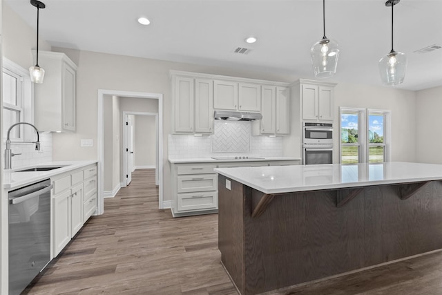 595 Fm 2968, Grapeland, TX 75844 - kitchen featuring stainless steel appliances, a sink, under cabinet range hood, backsplash, and light countertops