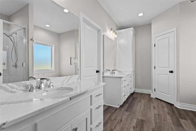 595 Fm 2968, Grapeland, TX 75844 - bathroom with two vanities, a stall shower, wood finished floors, baseboards, and recessed lighting