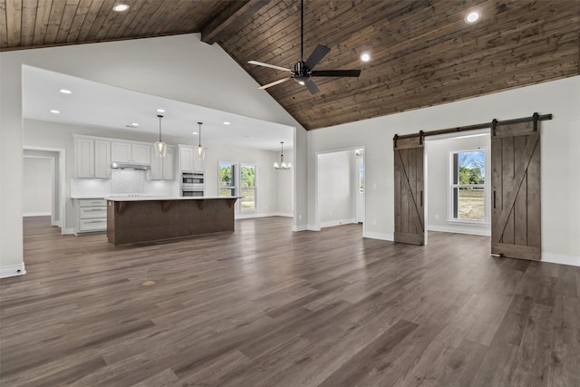 595 Fm 2968, Grapeland, TX 75844 - unfurnished living room featuring a barn door, recessed lighting, high vaulted ceiling, a ceiling fan, and wooden ceiling with exposed beams