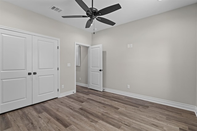 595 Fm 2968, Grapeland, TX 75844 - unfurnished bedroom with wood finished floors, baseboards, a closet, and a ceiling fan