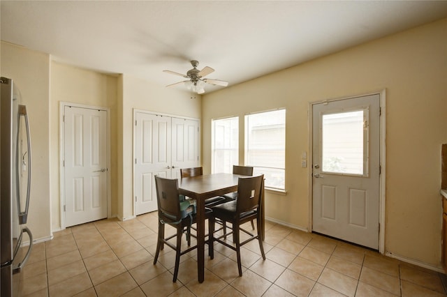 23610 Youpon Lake Ln, Spring, TX 77373 - dining space with ceiling fan, light tile patterned flooring, and baseboards