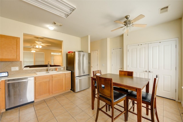 23610 Youpon Lake Ln, Spring, TX 77373 - kitchen with stainless steel appliances, ceiling fan, a sink, and light tile patterned flooring