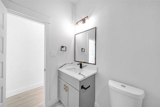 4902 Higgins St B, Unit A, Houston, TX 77033 - bathroom with toilet, vanity, baseboards, and wood finished floors