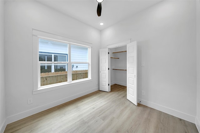 4902 Higgins St B, Unit A, Houston, TX 77033 - unfurnished bedroom with wood finished floors, baseboards, a walk in closet, a closet, and a ceiling fan