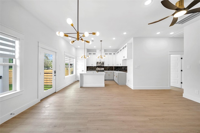 4902 Higgins St B, Unit A, Houston, TX 77033 - kitchen featuring a chandelier, stainless steel microwave, open floor plan, recessed lighting, and a kitchen island