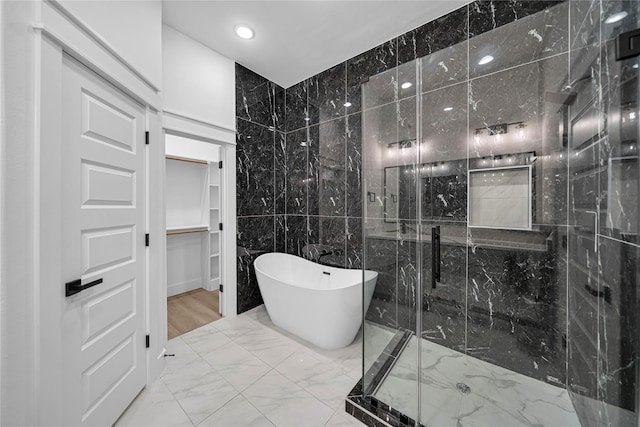 4902 Higgins St B, Unit A, Houston, TX 77033 - bathroom featuring marble finish floors, a freestanding bath, a marble finish shower, recessed lighting, and a spacious closet