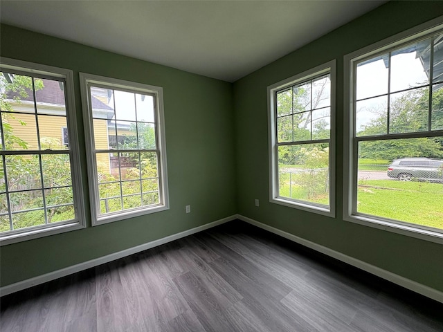 2385 Neches St, Beaumont, TX 77701 - empty room featuring baseboards and dark wood-type flooring