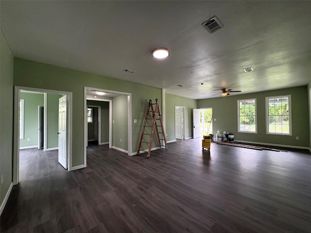 2385 Neches St, Beaumont, TX 77701 - unfurnished living room with dark wood-style floors, baseboards, and ceiling fan
