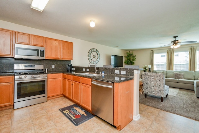 3434 Zephyr Glen Way, Houston, TX 77084 - kitchen with stainless steel appliances, a sink, open floor plan, a peninsula, and backsplash
