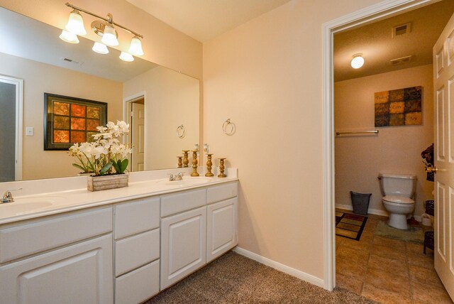 3434 Zephyr Glen Way, Houston, TX 77084 - bathroom with double vanity, toilet, and baseboards