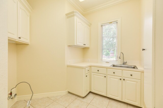 1 Heritage Oak Ct, Lake Jackson, TX 77566 - washroom featuring a sink, ornamental molding, baseboards, and light tile patterned floors