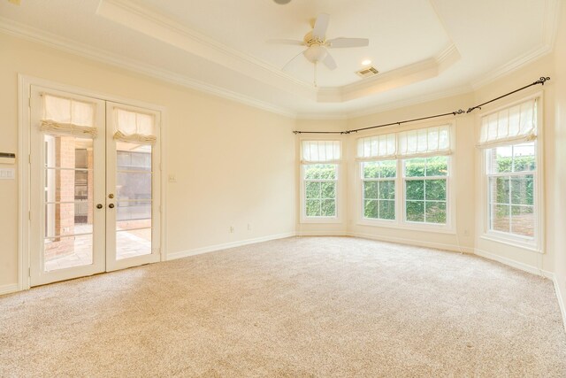 1 Heritage Oak Ct, Lake Jackson, TX 77566 - empty room with a tray ceiling, ornamental molding, healthy amount of natural light, french doors, and carpet