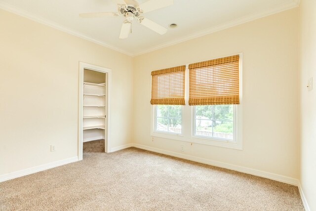 1 Heritage Oak Ct, Lake Jackson, TX 77566 - empty room with carpet flooring, baseboards, ornamental molding, and ceiling fan