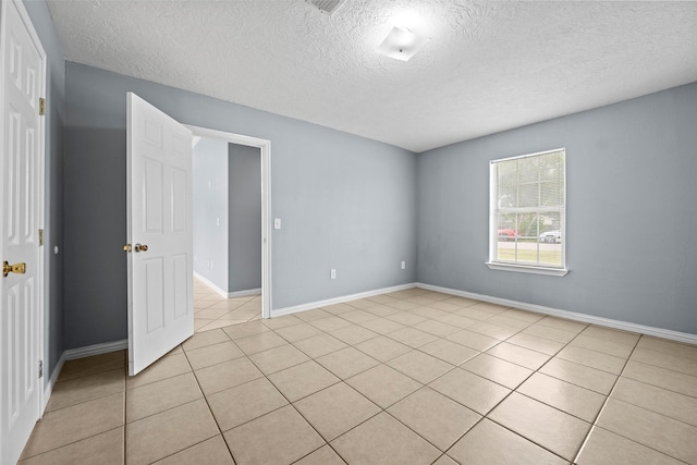 2401 Kingsdale Dr, Deer Park, TX 77536 - spare room with a textured ceiling, light tile patterned floors, and baseboards