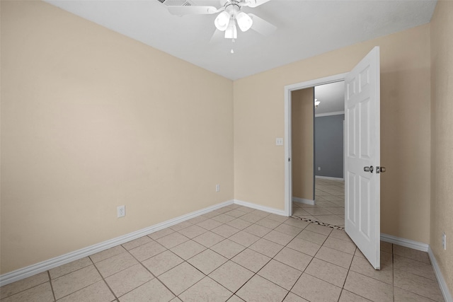 2401 Kingsdale Dr, Deer Park, TX 77536 - empty room featuring ceiling fan, light tile patterned floors, and baseboards