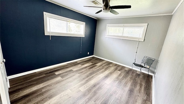 1105 S Main St, Highlands, TX 77562 - spare room with ornamental molding, wood finished floors, ceiling fan, and baseboards