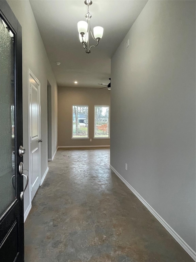 116 Indian Creek Cir, Willis, TX 77378 - hallway with concrete floors, baseboards, and a chandelier