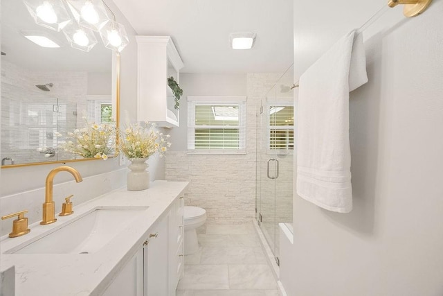 4502 Lido Ln, Houston, TX 77092 - bathroom featuring a stall shower, vanity, marble finish flooring, toilet, and tile walls