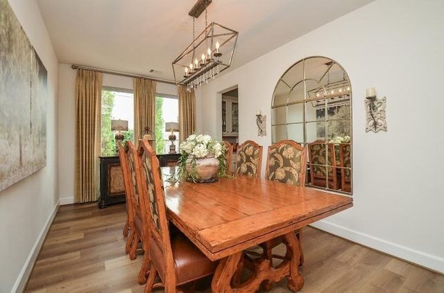 2038 Green Haven Ct, Missouri City, TX 77459 - dining room featuring wood finished floors, baseboards, and a chandelier