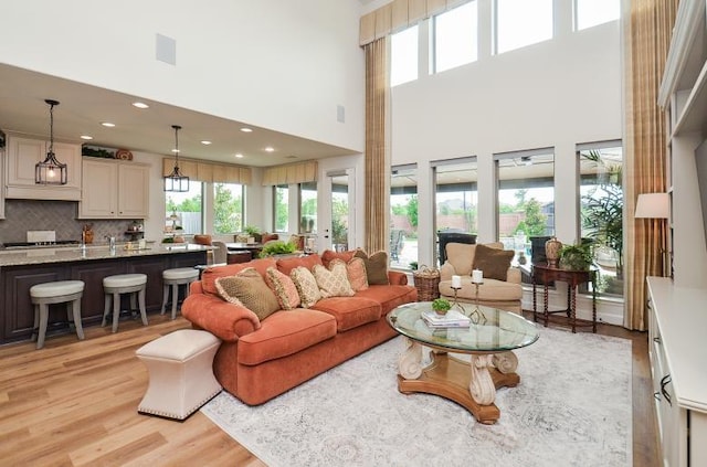 2038 Green Haven Ct, Missouri City, TX 77459 - living area with a high ceiling, light wood-style flooring, and recessed lighting